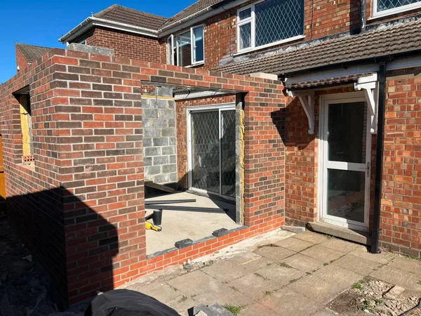 Single storey rear extension brick shell with door openings during brickwork