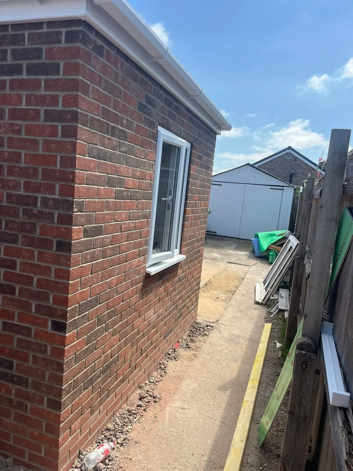 Brick extension side wall with a white window and neat pointing
