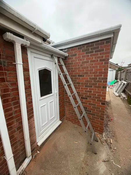 Brick extension with a new white rear door fitted after brickwork completion
