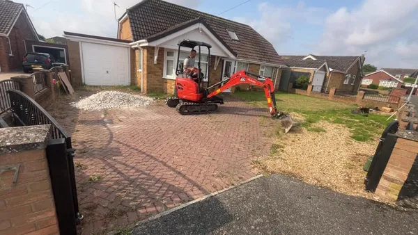 Front garden with old red block paving before patterned driveway replacement