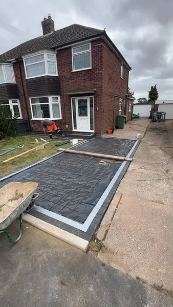 Concrete driveway base with charcoal block border laid during front drive work