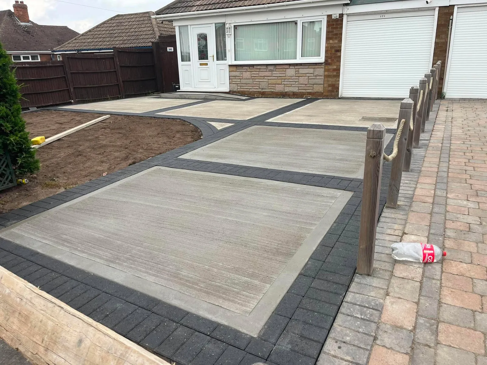 Concrete drive in panels with charcoal block borders after completion