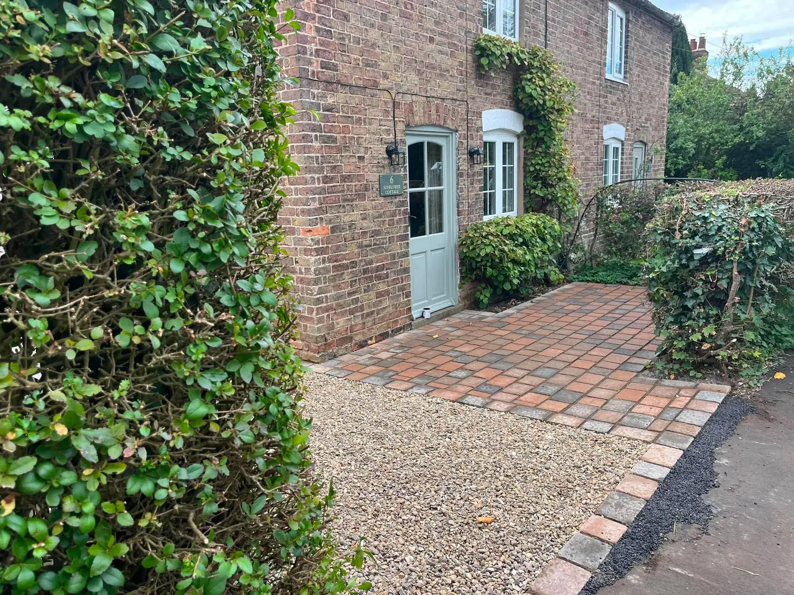 Gravel and multi coloured block paving in front of a cottage door after completion