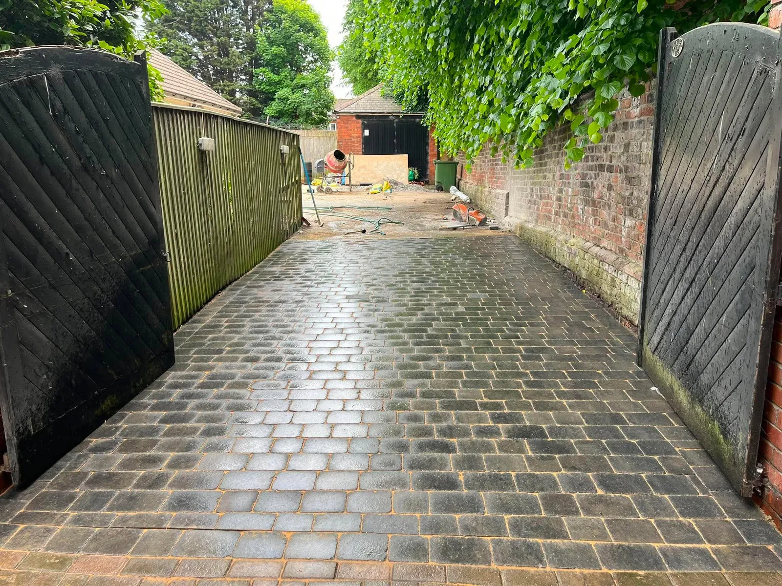 Tumbled block paving driveway washed and finished between wooden gates