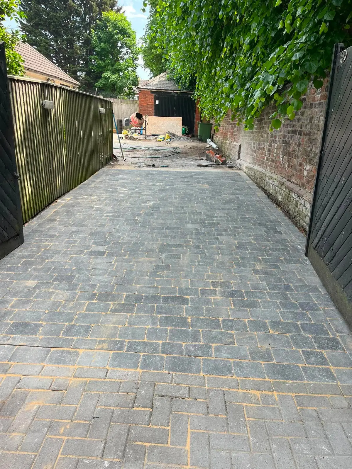Long tumbled block paving drive with sand still brushed in during laying