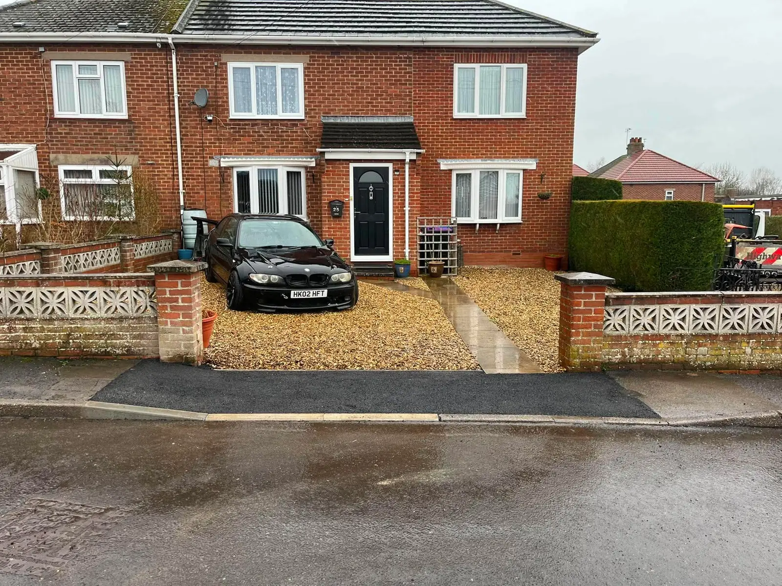 New dropped kerb and footpath crossing in front of a gravel driveway