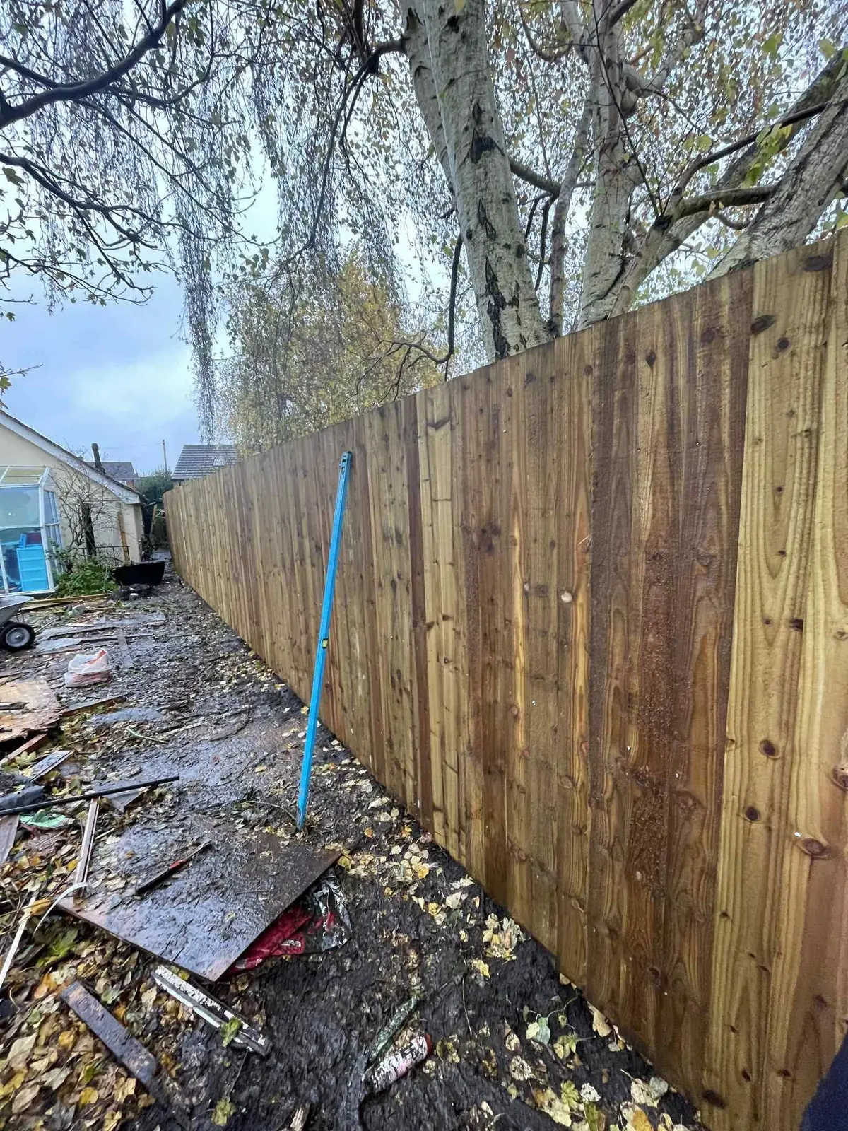 New close board wooden fence along a rear garden boundary after completion